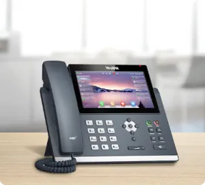 A modern feature-rich business phone sitting on a desk
